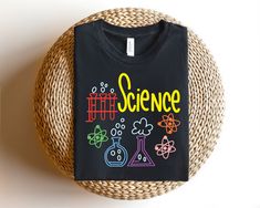 a t - shirt that says science on it sitting next to a wicker basket