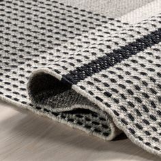 a close up view of a black and white rug