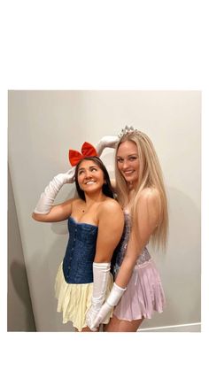 two women dressed in costumes posing for the camera