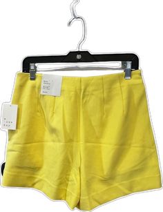 Yellow Fitted Short Bottoms, Yellow Stretch Short Length Bottoms, Yellow Stretch Bottoms Short Length, Yellow Stretch Short Bottoms, Yellow Stretch Bottoms Of Short Length, Stretch Yellow Bottoms In Short Length, Trendy Yellow Shorts With Pockets, Neon Yellow Stretch Bottoms For Summer, Yellow Stretch Short Leg Bottoms