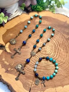 Collection of rosaries, bracelets, and chaplets handcrafted with high quality blue gemstones and accented with a solid bronze crucifix and Saint Anthony medal.  All beads used are made from natural gemstones. Therefore, each bead is unique and might have slight color difference or imperfections.  Size & Customization Please message me for alternate size options. I am happy to accommodate custom orders. Please message me with your specific requests.  Care Many gemstone, crystal, and wood beads sh Catholic Rosary Bracelet, Chaplet Rosary, St Anthony, Saint Anthony, Catholic Rosary, Catholic Jewelry, Rosary Bracelet, Rosary Catholic, Catholic Gifts