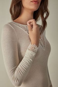 Long-sleeved modal cashmere ultralight shirt enhanced with lace. Feminine V-neck Tops With Lace Sleeves, Elegant Long Sleeve Tops With Lace Cuffs, Elegant Long Sleeve Top With Lace Sleeves, Elegant White Viscose Top, Elegant Delicate Lace Top For Fall, Feminine Long Sleeve Tops With Delicate Lace, Chic Tops With Lace Cuffs For Daywear, Chic Tops With Lace Trim For Loungewear, Elegant White Tops With Delicate Lace