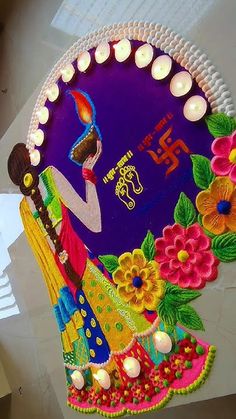 a decorated plate with candles on it and a woman holding a cake in her hand