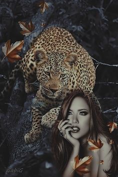 a beautiful woman with long hair standing in front of a leopard on a tree branch