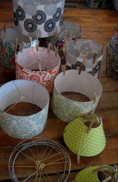 several baskets with clothes pins attached to them on a wooden table next to other items