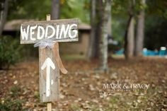 a wooden sign that says wedding with an arrow on it