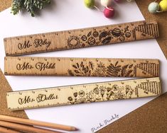 three rulers with the words mr and mrs engraved on them next to some pencils