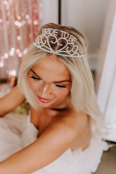 a woman with blonde hair wearing a tiara