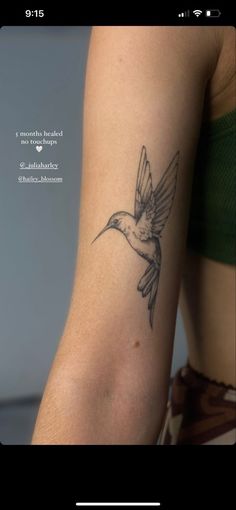 a woman's arm with a hummingbird tattoo on the left side of her arm