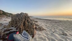 the beach is covered in sand and rocks