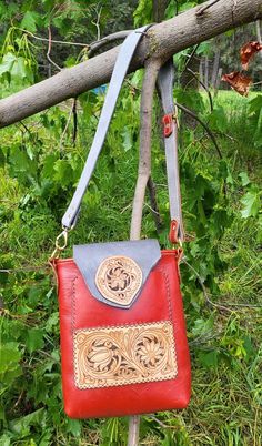 Hand Made Red Leather Tote Type Bag of leather with a stiffer or somewhat firm temper. This bag has an adjustable shoulder or cross body strap to 39″ in the prettiest slate gray leather and matching red leather on the buckle side. This bag is approximately 9.3/4″ Tall x 8.3/4″ wide at the top and 2″ across at the bottom. It has a magnetic top flap closure of the same gray leather as the strap, that also secures the outside pocket. Brass hardware. There is one hanging pock Red Leather Saddle Bag Shaped As Satchel, Red Leather Saddle Bag In Satchel Shape, Red Leather Satchel Saddle Bag, Red Leather Rectangular Saddle Bag, Red Leather Saddle Bag With Detachable Strap, Red Rectangular Satchel With Leather Lining, Red Leather Saddle Bag With Adjustable Strap, Red Leather Pouch Shoulder Bag, Red Crossbody Satchel With Leather Lining