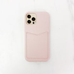 a pink iphone case sitting on top of a white table