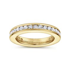 a yellow gold wedding band with channeled diamonds