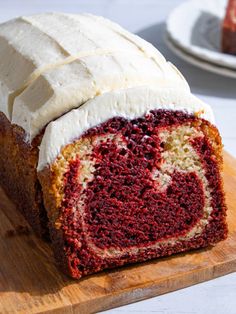 a piece of red velvet cake with white frosting