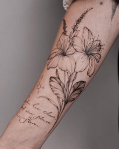 a woman's arm with flowers on it and the words hope written in cursive writing