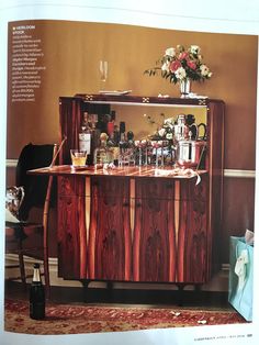 an article in the magazine shows a bar with bottles and glasses on it