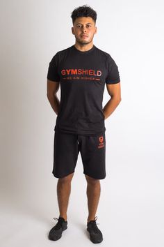 Sleek, trendy and functional design, these Gym Shield carrot fit shorts are ideal for your active streetwear range.  A low cut crotch, slim fit with a pleasant stretch effect and sweat wicking fabric which will keep you dry and cool.  Manufactured with a fabric blend of cotton and polyester which will enhance your performance during workouts while providing ultimate comfort.  Finished with Gym Shield Original Logo.  60% Cotton, 40% Polyester Model is 5’9″ and wears size S Mens Workout Pants, Gym Tshirt, Men's Workout, Gym Workout Outfits, Functional Design, Gym Men, Gym Outfit, Black Shorts, Workout Pants