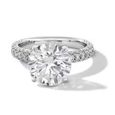 a round cut diamond ring with pave set shoulders