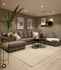 a living room filled with furniture and pictures on the wall