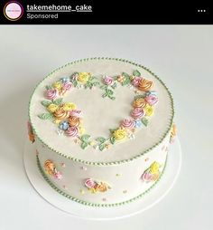 there is a cake decorated with flowers on the top and bottom, as well as letters