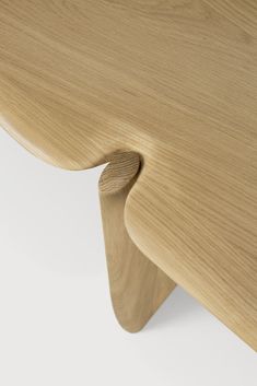 a close up view of a wooden table with curved legs and wood grained surface