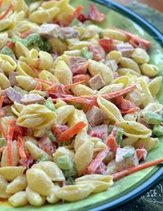 pasta salad with ham and broccoli on a green platter in front of the words easy sweet hawaiian pasta salad