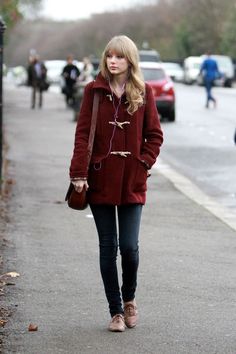 four different pictures of women in coats and jeans, one is wearing a beanie