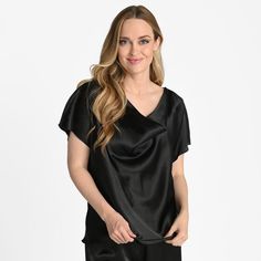 Classy and sophisticated, this Tiana B satin cowl neck top is a great way to add some shine and flair to your outfit! The cowl neckline joins a short sleeve style to create a unique and airy silhouette. Lightweight and sophisticated, you can pair this blouse with jeans for a casual look or dress it up with a pretty skirt! Black Cowl Neck Top For Night Out, Silk Cowl Neck Top For Night Out, Black Cowl Neck Top For Party, Black Cowl Neck Top For Evening, Black Satin V-neck Top, Black Satin Sleek Top, Black Satin Tops With Sleek Style, Sleek Black Satin Tops, Sleek Satin Finish Tops For Night Out