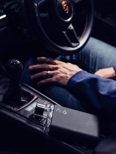 the man is driving his car and holding on to the steering wheel with both hands