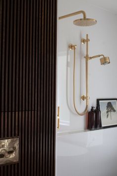 a bathroom with a shower head and hand held shower faucet in the wall