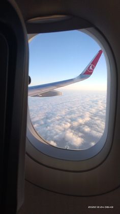 an airplane window looking out at the clouds