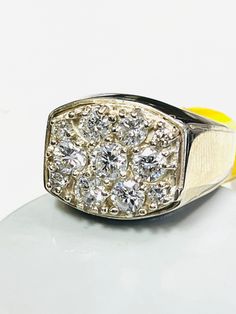 a yellow and white ring sitting on top of a table