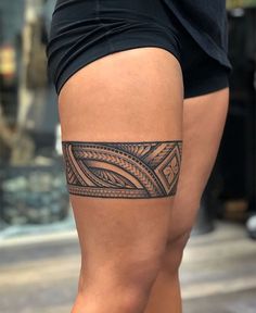 a woman's leg with a tattoo on the lower part of her thigh and an intricate design