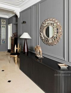 a living room filled with furniture and a mirror on the wall