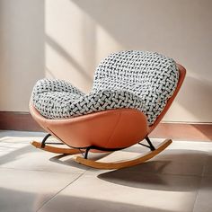 a rocking chair with black and white fabric on it