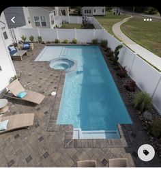 an above ground swimming pool with lounge chairs around it