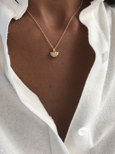 The Mini Shell Pendant necklace is a petite and elegant staple for layering and is perfect for summer lovers to wear year round to remind them of favorite beach days. Pendant is cast in brass and 14k gold plate. The pendant and bail are one unit. Chains are metal and 14k gold filled. Made in the USA Measurements: .5" length (with bail) / .5" width / .125" depth pendant 18" length / 1.2mm venetian box chain or 16" / 1.5mm link chain *Listing is for one individual necklace with pendant - some phot Elegant Luxury Shell Pendant Necklace, Dainty Yellow Gold Jewelry For Summer, Gold Charm Necklace For Summer Gifts, Delicate Gold Jewelry For Summer, Delicate Gold Summer Jewelry, Minimalist Necklaces For Summer Gifts, Elegant Gold Charm Necklace For Summer, Gold Sterling Silver Jewelry For Summer, Elegant Summer Charm Necklaces As Gifts