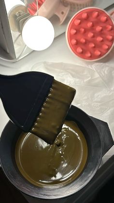 a spatula being used to spread chocolate on top of a pan