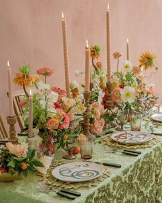 the table is set with flowers and candles