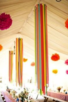 an instagram photo of a tent with colorful ribbons hanging from the ceiling