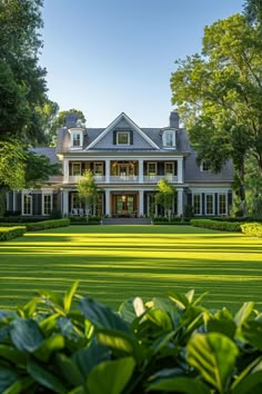 a large white house surrounded by lush green trees