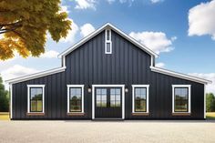 a large black barn with three windows on the front