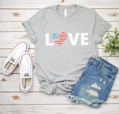 a t - shirt with the word mama on it next to ripped jeans and sneakers