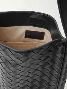 "When creating a Bottega Veneta bag, we count days, not hours, " says the brand. Artisans in Italy have handcrafted this messenger bag by meticulously weaving strips of leather in the signature intrecciato technique. It's roomy enough to carry your tablet, water bottle and a hard case for your sunglasses. Luxury Leather Satchel With Woven Detail, Luxury Bucket Bag With Intrecciato Weave, Business Shoulder Bag With Intrecciato Weave, Luxury Rectangular Bucket Bag With Leather Handles, Formal Woven Leather Bucket Bag, Designer Business Shoulder Bag With Braided Handles, Designer Shoulder Bag With Braided Handles For Business, Designer Intrecciato Weave Bucket Tote Bag, Designer Leather Shoulder Bag With Intrecciato Weave