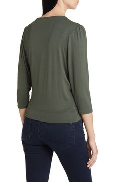 Cut from a soft, drapey jersey knit with an easy faux-wrap design, this top is an ideal choice for both casual looks or more styled up outfits. 23" length Surplice V-neck Three-quarter sleeves 95% rayon, 5% spandex Machine wash, dry flat Imported Solid Color V-neck Faux Wrap Top, V-neck Faux Wrap Top For Layering, Casual Elastane Blouse For Fall, Spring Casual Wrap Top For Layering, Casual Wrap Top For Spring Layering, Casual V-neck Stretch Wrap Top, Casual Stretch V-neck Wrap Top, Long Sleeve Faux Wrap Top For Layering, Spring Long Sleeve Top With Twist Front