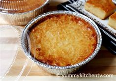 three pies in tin pans sitting on top of a wooden table