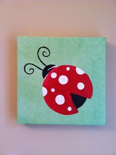 a painting of a ladybug on a green background