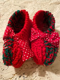 One size fits most. These slippers measure 8 1/2 inches when not stretched. The model in the photo wears a size 10 shoe so these slippers fit most women. I knitted them out of two strands of red heart, acrylic yarn, making them extra warm and cozy. First strand of yarn is a bright red and the second strand is a variegated of red, green, and white. I tied a cloth bow on the slippers which can easily be removed if you prefer. These slippers are like grandma used to knit! Hand Knitted Yarn Slippers For Winter, Casual Crochet Slippers For Winter, Casual Crochet Winter Slippers, Casual Winter Yarn Slippers, Casual Crochet Yarn Slippers, Comfortable Crochet Yarn Slippers, Cozy Yarn Slippers With Round Toe, Crochet Yarn Slippers With Round Toe, Cozy Knitted Yarn Slippers