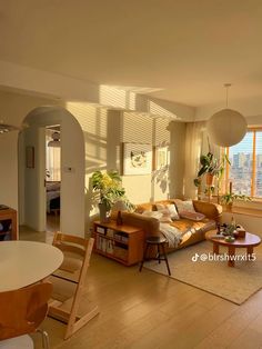 a living room filled with furniture and lots of windows