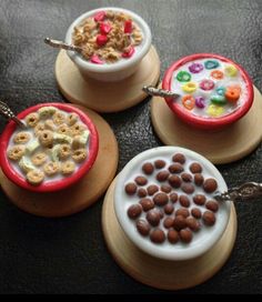 three small bowls filled with cereal on top of wooden plates